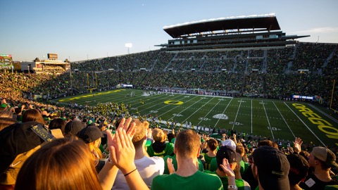 Fisheye view of the student section at a Ducks football game