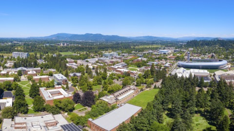 An fisheye aerial view of campus looking towards hills in the background.